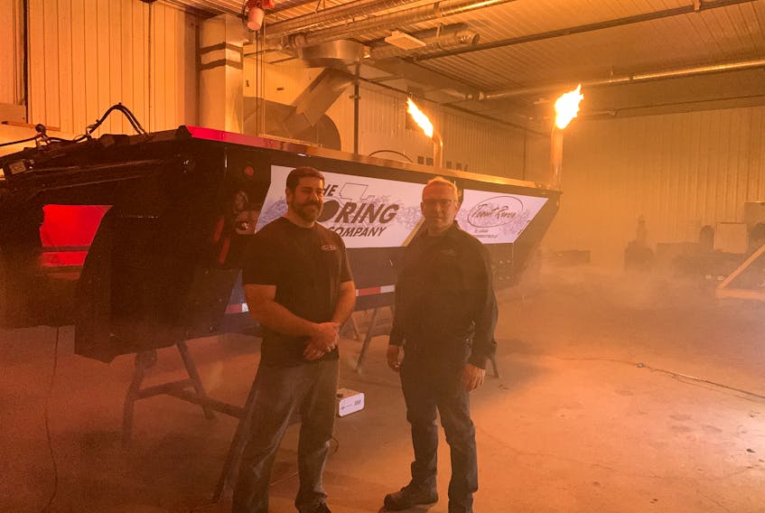 Darrin Mitchell, left, president of Trout River Industries and company founder Harvey Stewart standing next to the modified trailer their company build for the Elon Musk-owned Boring Company.