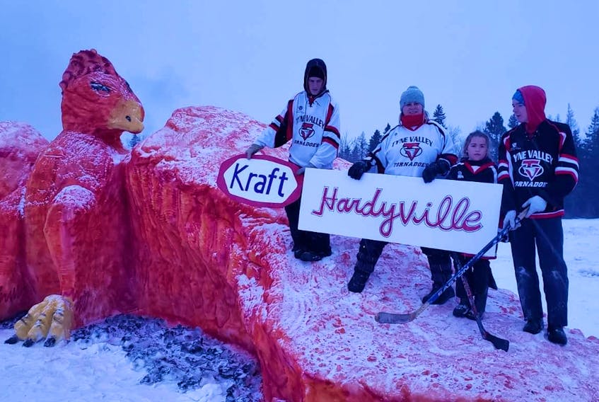 Members of the Hardy family, from left, Bradley Hardy, Janet Hardy Callaghan, Emma Hardy and Landon Bulger pose with their Kraft Hardyville sculpture they helped create for the Tyne Valley Winter Carnivals snow sculpture competition. The design stems from the idea of a phoenix rising from the ashes.