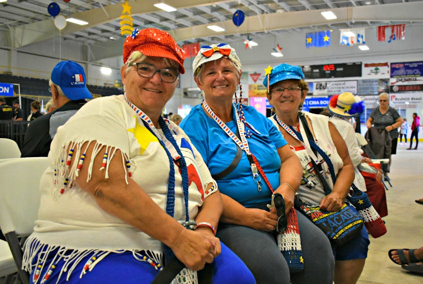 Sisters Lucille Arsenault, left, Sylvia Gallant and Eveline Doiron reunite with family members at the Acadian World Congress.