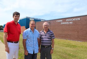 The Évangéline Region will get its new school sometime in the next few years. Celebrating that announcement are Nick Arsenault, left, a parent at the school and director of its community council, Gilles Benoit, centre, president of the French Language School Board, and Gabriel Arsenault, chair of the school renewal committee.