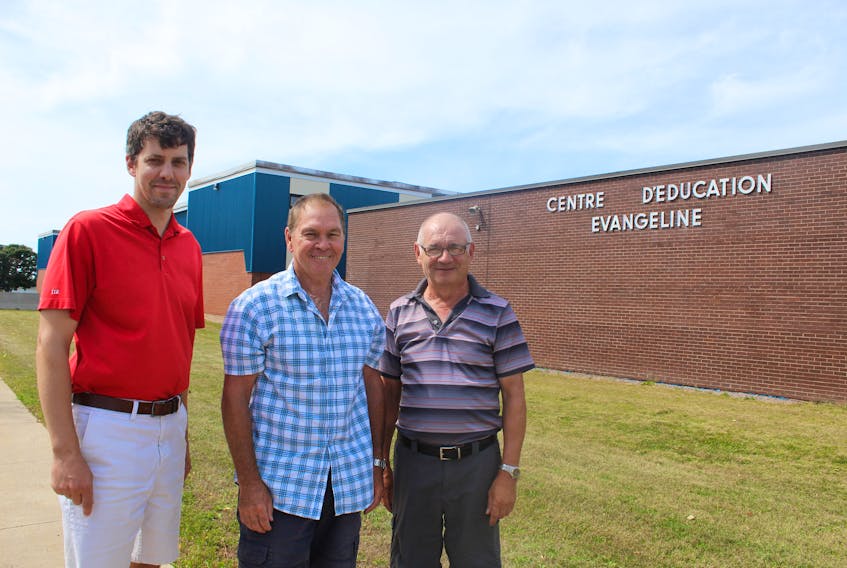 The Évangéline Region will get its new school sometime in the next few years. Celebrating that announcement are Nick Arsenault, left, a parent at the school and director of its community council, Gilles Benoit, centre, president of the French Language School Board, and Gabriel Arsenault, chair of the school renewal committee.