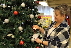 Debbie Taylor-Gallant hung a decoration and lit a Christmas tree light Monday in remembrance of her husband Earl Gallant, as part of Hospice P.E.I.’s annual Let Their Light Shine campaign. The annual fundraiser is celebrating its 25th anniversary this year.
