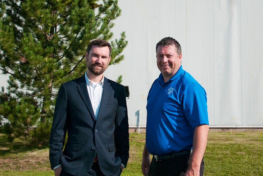Kirk McKinnon, left, MacDougall Steel Erectors chief financial officer, and Economic Growth Minister Matthew MacKay, outside that company’s Albany facility. MacDougall Steel announced Thursday it is moving to establish its own parts manufacturing facilities.