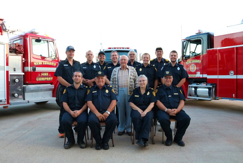 Arthur Johnston, centre, among members of the New London Fire Company following a recent gathering where he saw the two new-to-them truck his donation to the company paid for. Millicent McKay/Journal Pioneer