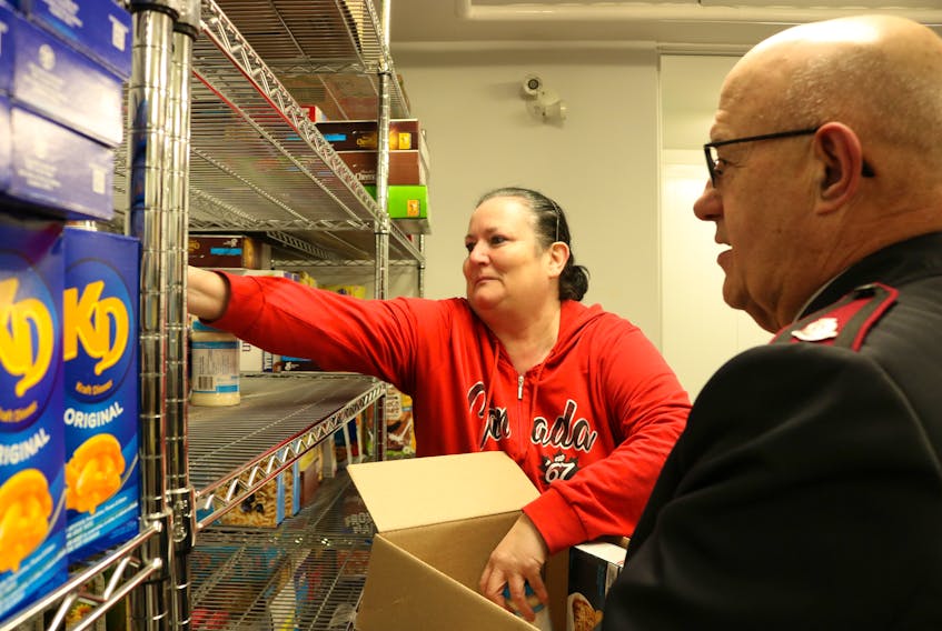 Darlene MacDonald, manager of the Summerside Salvation Army Food Bank, gets help from Major Wayne Green to fill a Christmas Hamper. Millicent McKay/Journal Pioneer