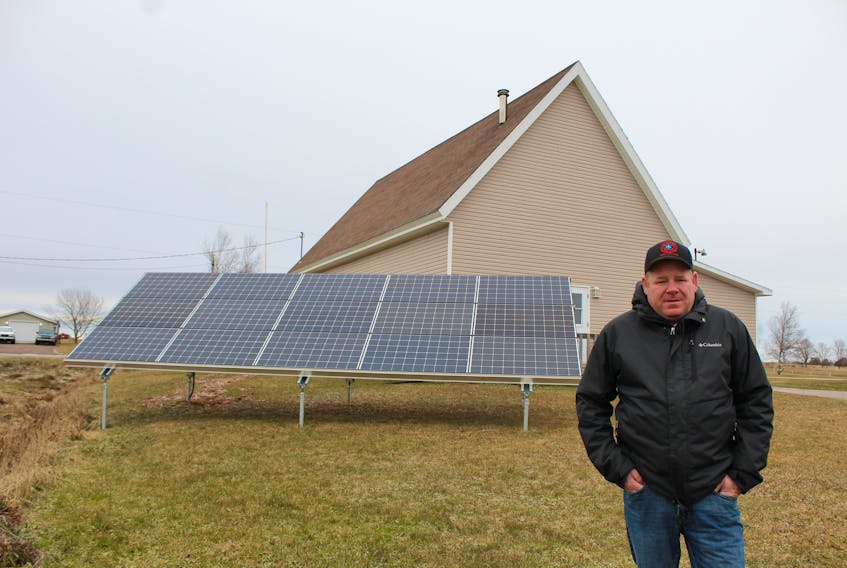 Colin MacLean/Journal Pioneer 
Mayor Jason Woodbury, of the Rural Municipality of St. Nicholas, stands with his community’s newest piece of infrastructure, a 4.65-kilowatt solar panel system, which is now providing enough electricity to offset the cost of the village hall’s annual electric bill.