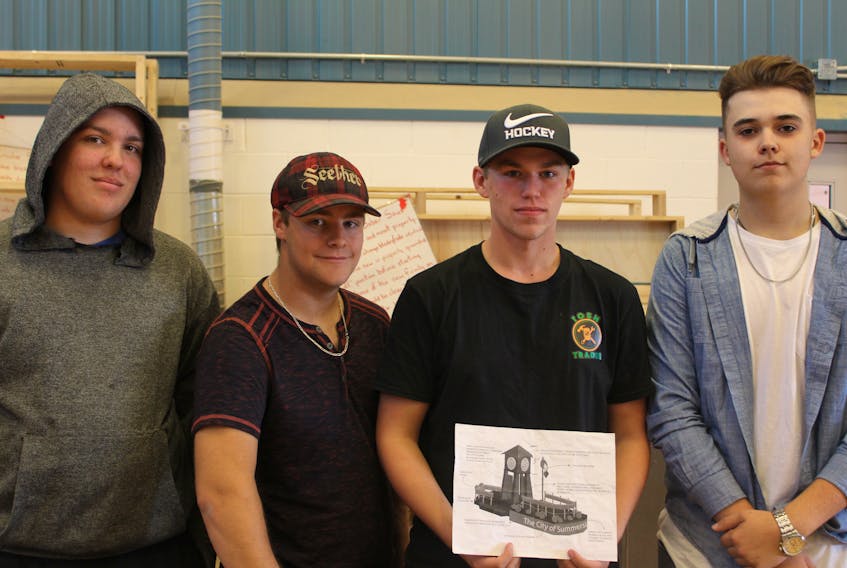 Three Oaks students Jonah Gallant, left, Danny Campbell, Dakota Campbell and Andrew Cameron displaying the blueprint they used when their class rebuilt the Summerside float last spring.