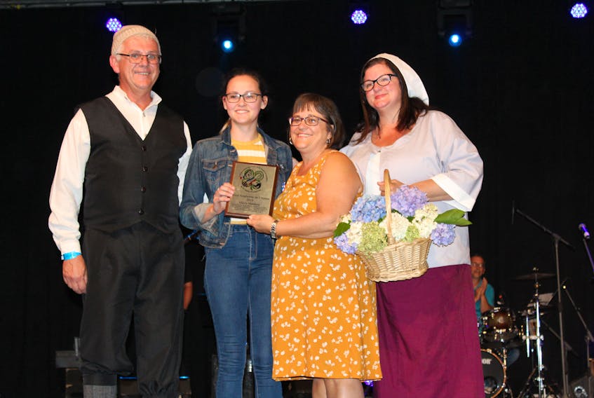 Blair Arsenault (as Gabriel), left, presents Alexis Matthew the Young Acadian of the Year Award along with Jeanne Gallant, president of the Agricultural Exhibition and Acadian Festival, and Angela Pendergast-Arsenault (as Evangeline).