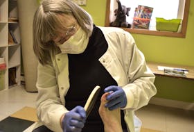 Shirley Spence examines a callus on a client’s great toe at her free foot care clinic at the Summerside Baptist Church. Alison Jenkins/ Journal Pioneer.