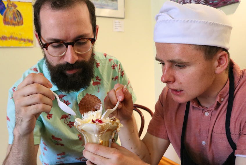 Brendan Henry, left, and Daniel Meister chow down on a sundae in honour of kicking off Henry’s business, Minotaur Creative’s launch of A Month of Sundaes. The campaign features seven Prince County dairy bars from Chelton to Tignish.