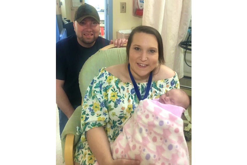 Gerald Wells, left, and Thana Deagle share a moment with their daughter, Bexx, who is waiting for a heart transplant. She was diagnosed with a congenital heart defect known as hypoplastic right heart syndrome. Submitted/Thana Deagle