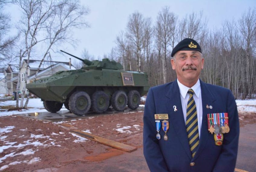 Ret. Sgt. Dave Redmond stands with a decommissioned LAV III, Kodiac, recently installed as a monument outside the Wellington Legion as a monument to the Afghanistan War. Redmond helped bring the vehicle to P.E.I. and commanded a similar vehicle during his own time in Afghanistan