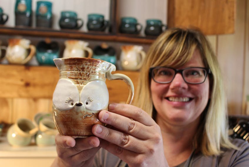 Crystal Stevens, of Redrocks Pottery in North Bedque, shows off Jax, one of the individually named creations from her PEI Fox Mugs brand.