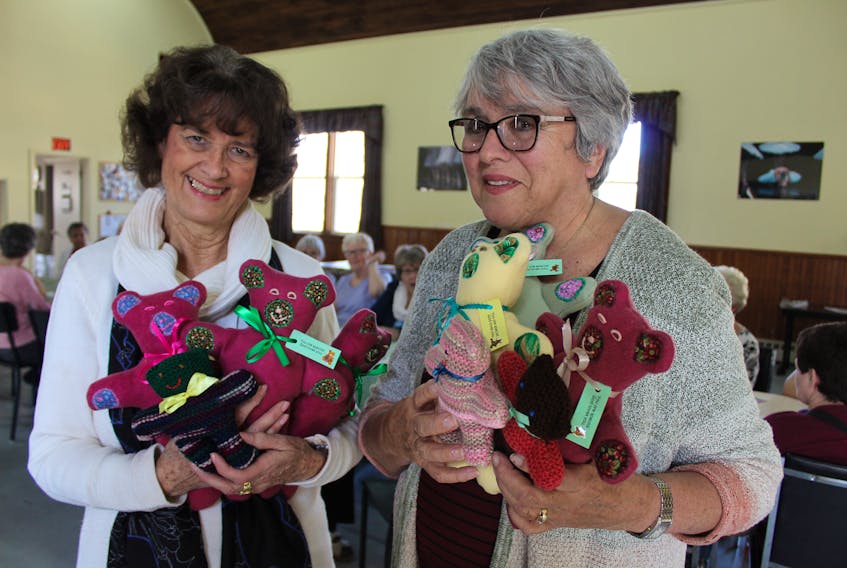 Katie Hickox, left, and Margret Arsenault holds some teddy bears created by Summerside group Kuddles for Kids for children all over the world. Arsenault is a volunteer with the group and Hickox is helping them distribute their creations to a South African community she has worked with in the past.