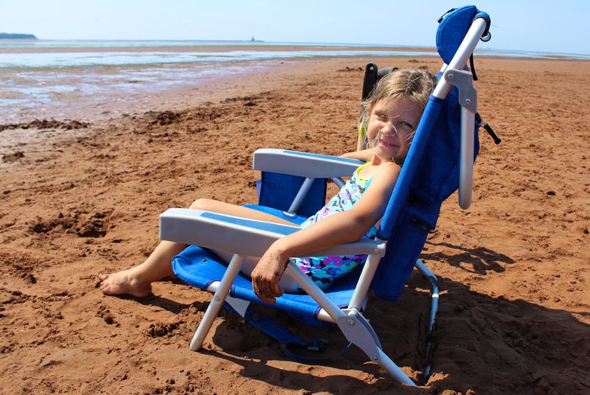 Six-year-old Rose, of Summerside, found a great spot to idle away the day with her family as the outdoor temperature, including humidity, was nearing 40 C.