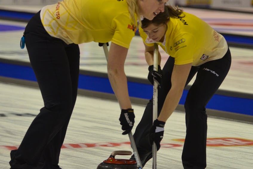 The 2017 Home Hardware Road to the Roar Pre-Trials curling event got underway at Eastlink Arena on Monday afternoon. Heather Rogers, lead for the Nadine Scotland rink from Calgary, and second stone Rebecca Konschuh sweep a rock during Draw 1. Jason Simmonds/Journal Pioneer