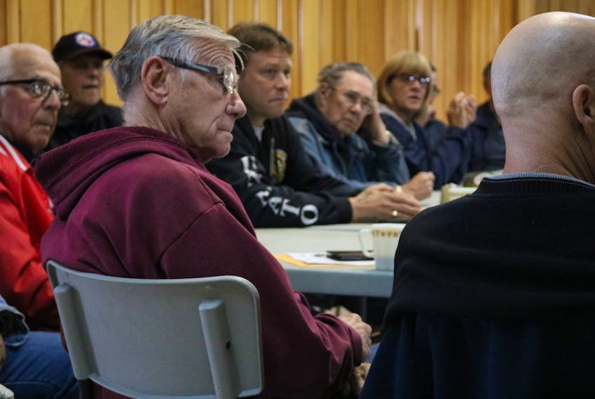 Dennis Hopping, centre, listens as a veteran from the OSISS and Brave and Broken support group shares a recent meeting.