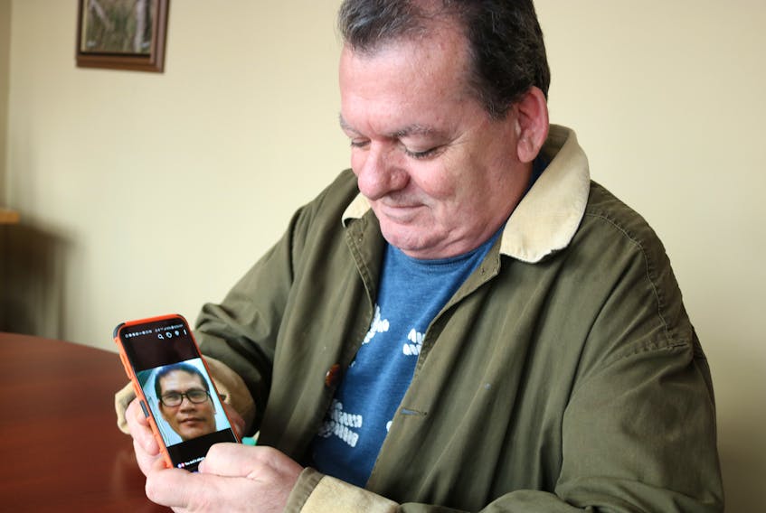 Eddie Hackett can’t help but smile when he looks at a photo of his husband, Rey Roque Cunanan, who lives in the Philippines.