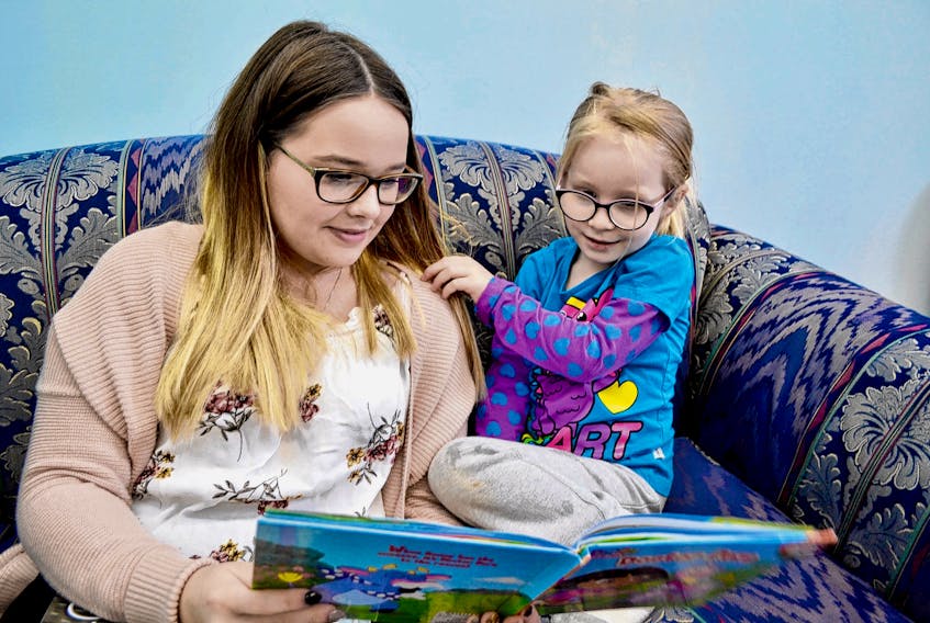 Hannah Adams, three, enjoys some one-on-one story time with CHANCES early learning centre staff member Tori McCue.
