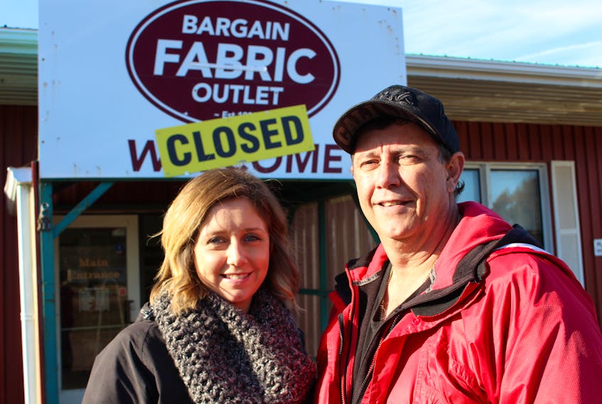 Ashley Guergis-Greencorn, left, and her father, Eddie Guergis outside the Bargain Fabric Outlet.