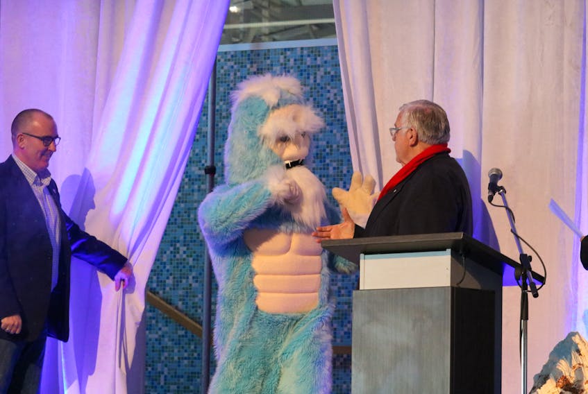 Chris Palmer, economic development and tourism minister, left, lets ‘Barbegazi,’ meaning winter beard, out from behind the curtain. The winter beast got a fist bump from Summerside Mayor Basil Stewart following the event announcement at Credit Union Place which will host the Barbegazi Winter Sports Festival from Jan. 18 to 19.