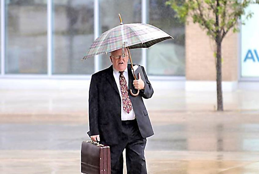 Harold Alan Stewart arrived at the Oshawa, Ont., courthouse for the start of his trial Monday, Sept. 10. Stewart, identified by police as minister of a church in Prince Edward Island, is accused along with two others of defrauding an elderly Oshawa widow of hundreds of thousands of dollars. - Ron Pietroniro /Metroland