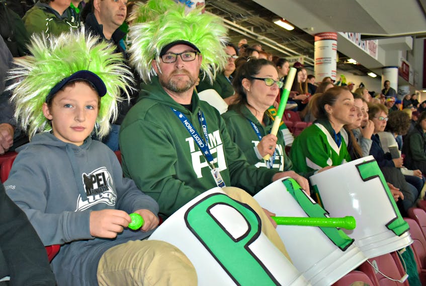 Sheila, from the right, Wayne, and Ashton Peters drummed up support for the Under-16 Wave that made the playoffs at the Canadian ringette championship on Saturday morning.