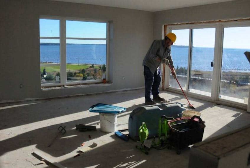 A worker cleans up in the room with the best view of Summerside Harbour in the Tides at Harbour’s Edge development on MacKenzie Drive.