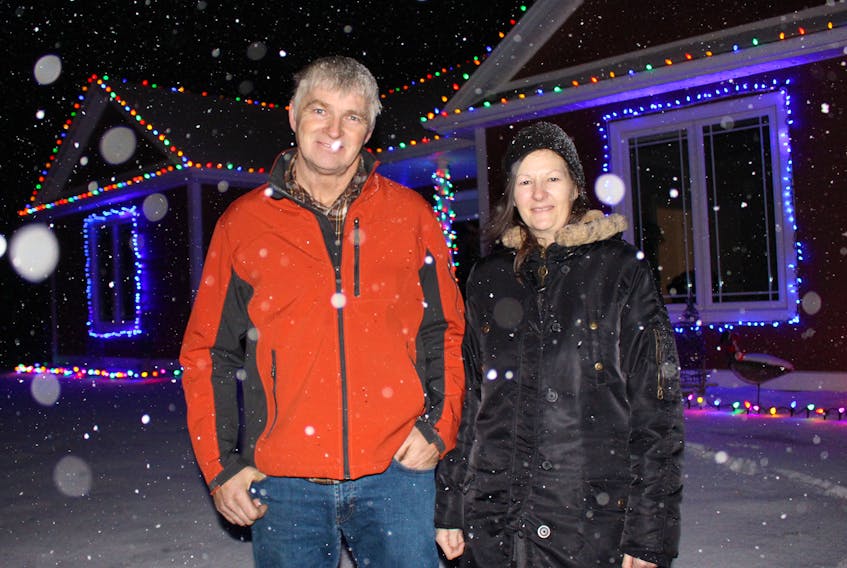 Wayne, left, and Barbie Locke outside their home in Indian River. The pair is known for their musical Christmas lights display, which they put up every year.
