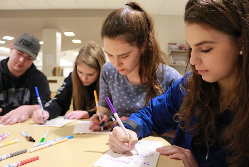 Cancer Survivor Pacey MacIsaac, left, Jadyn Gallant, Haley Brennan and Georgie McKenna begin working on label luminaries for the school’s second Youth Relay for Life. The event is set for May 16 at 4:30 at the school’s bus parking lot.