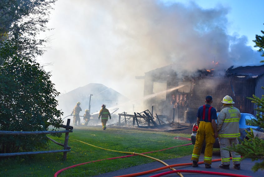 Kensington firefighters work to extinguish a blaze that broke out late Sunday afternoon. The fire has destroyed a house and displaced a family of four.
