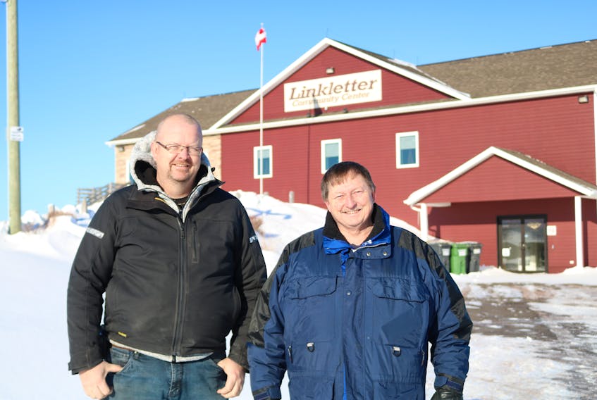 Trevor Callbeck, left, deputy mayor of the Rural Municipality of Linkletter and David Buell, mayor, are excited about making tracks for greener energy as work continues on the installation of a 56-panel solar power unit that will supply the Linkletter Community Centre with about 90 per cent of its power.