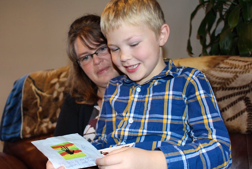 Lucas Jeffery reads Nolan Faber’s letter with his mother, Rachel. Lucas was inspired to write a letter for Nolan, a young boy with Treacher Collins Syndrome, after reading the book “Wonder”.