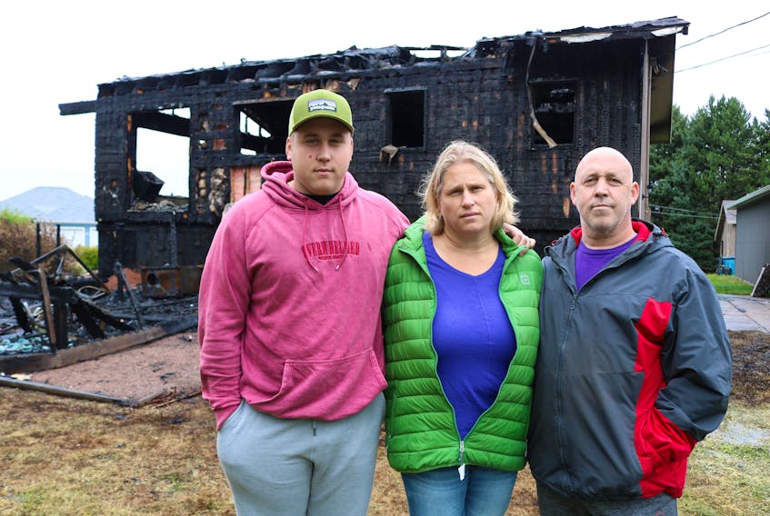 Jake Reynolds, 22, with mom Lynn and father Tim following a house fire that destroyed the family’s home in Schurmans Point on Sept. 16.