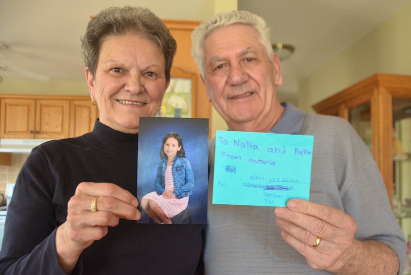 Nancy and Joe Lawless, of Summerisde, hold up an interesting letter they received recently from their granddaughter, Octavia Dixon-Lawless (in picture), from B.C.