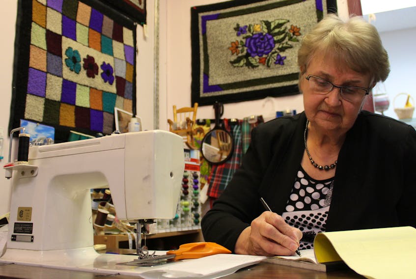 Doris Flamminio tallies up a receipt at her shop, Island Memories Gifts.