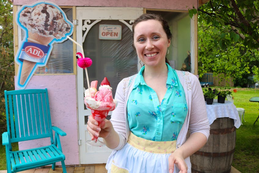 Mary Webster, owner of Madame Moos Dairy Bar in Chelton, and her business’s signature treat, the ‘Flaming Flamingo.’