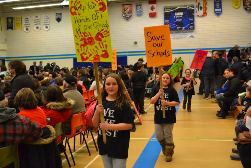 Children in We the West T-shirts carried messages during the Westisle Family of Schools' public meeting in February. On Monday the Board of Directors of the Public Schools Branch rejected recommendations calling for the closure of two schools in the family.