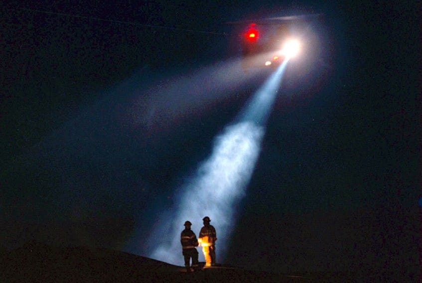A search and rescue helicopter and first responders on shore during the search that followed the crash of Swiss Air flight 111 in September 1998 off the coast of Nova Scotia. – TIM KROCHAK/HALIFAX CHRONICLE HERALD file photo