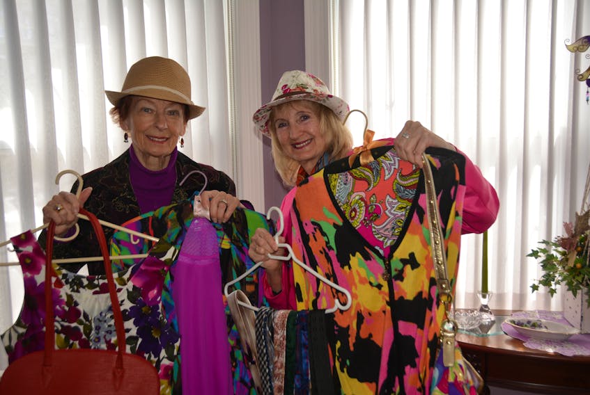 Dorothy Bernard (left) and Mary Curran display pieces of clothing for sale at the Presbyterian Church in Summerside this weekend. -Taya Gaudet photo