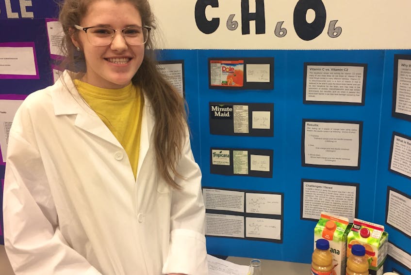 Grade 9 student Anna Clark shows the results of her study at the Summerside Intermediate School science fair March 7. -Ethan Paquet photo