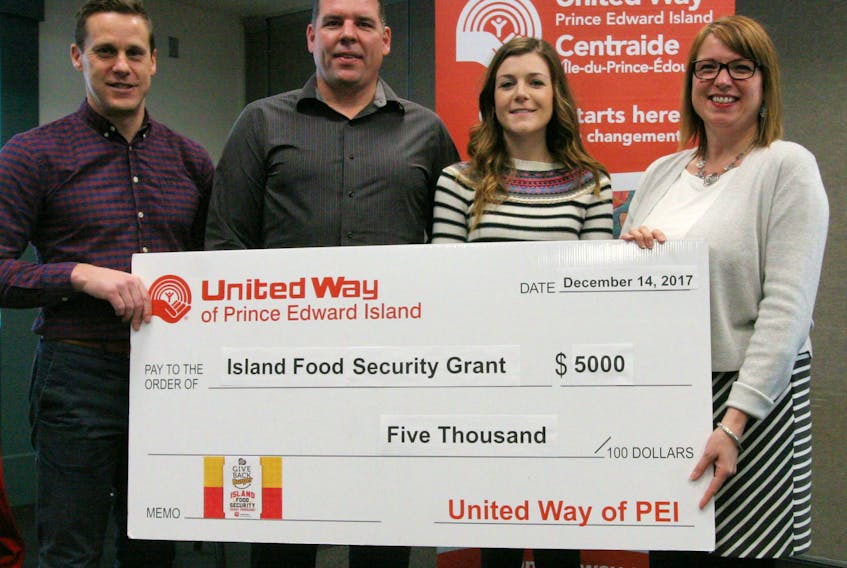 Recipients Adam Binkley and Nicole Babineau from Summerside Boys and Girls Club (center) with Rob Lantz (left) United Way of P.E.I. Board President and President of Fresh Media and P.E.I. Burger Love Melody Dover (right).