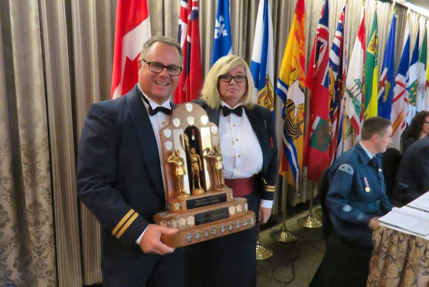 Commanding Officer of 53 Sqn. Capt. James Harper accepts the award for top P.E.I. squadron from retired Capt. Kendra Mellish, chairwoman of the Air Cadet League of Canada.
