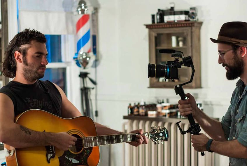 Brendan Henry, right, films Adam Baldwin in one of the Barber Shop Sessions that have been nominated for an ECMA.