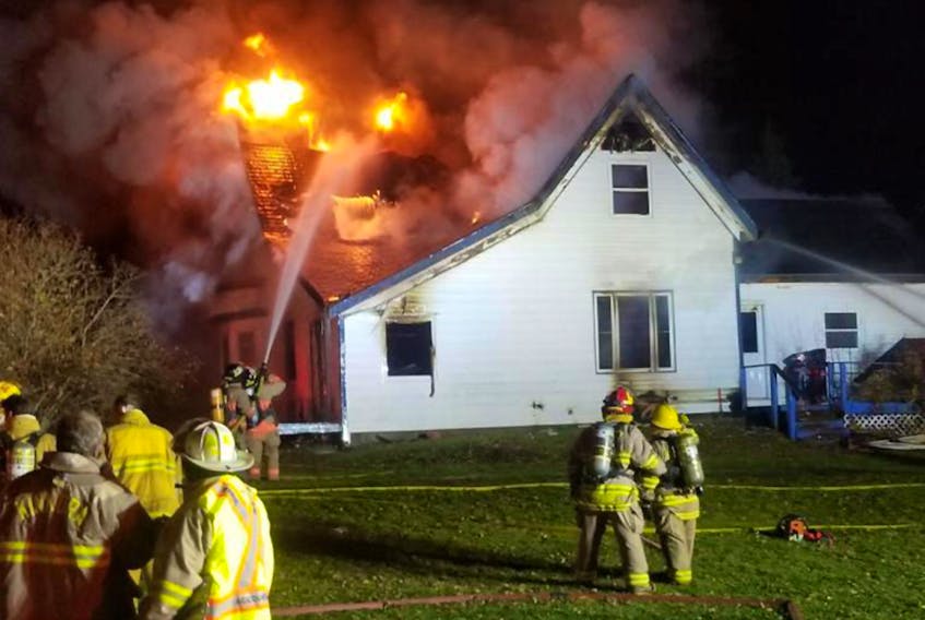 Kinkora Firefighters fight to bring a tough fire in South Freetown under control, Monday night.