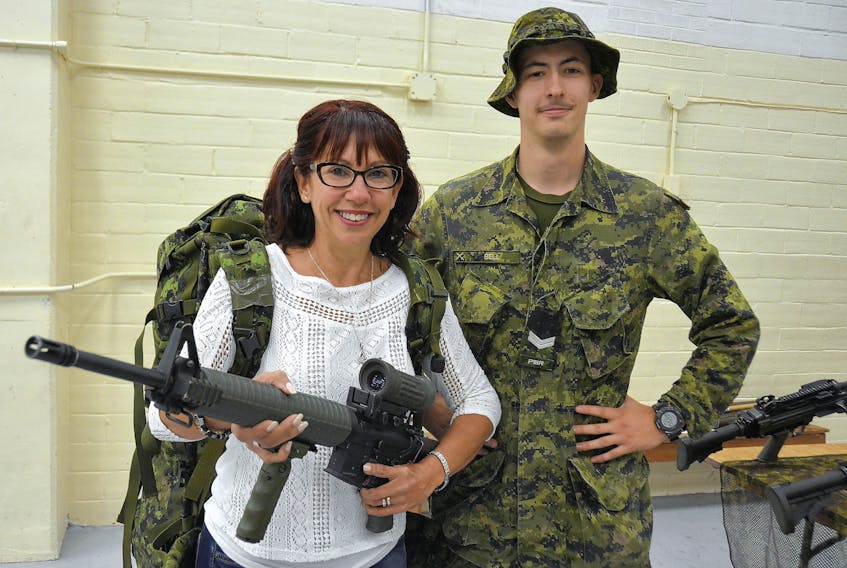 Cpl. Tyler Bell gives Lilia Silliker, from Kensington, hands on experience with (unarmed) weaponry on display during an open day. Desiree Anstey/Journal Pioneer