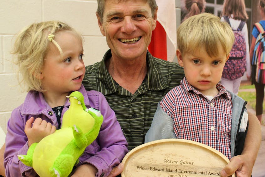 Long-time environmental volunteer Wayne Gairns, of Emyvale, won the P.E.I. Environmental Award in the individual category. Gairns was in Kensington Monday to accept the award with his grandchildren, Stella Brioux and Grady Gairns.