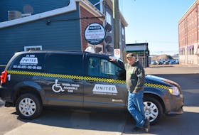 Myles Doucette, manager of United Summerside Taxi Inc., shows off one of the company’s wheelchair accessible vans outside the taxi stand April 10.