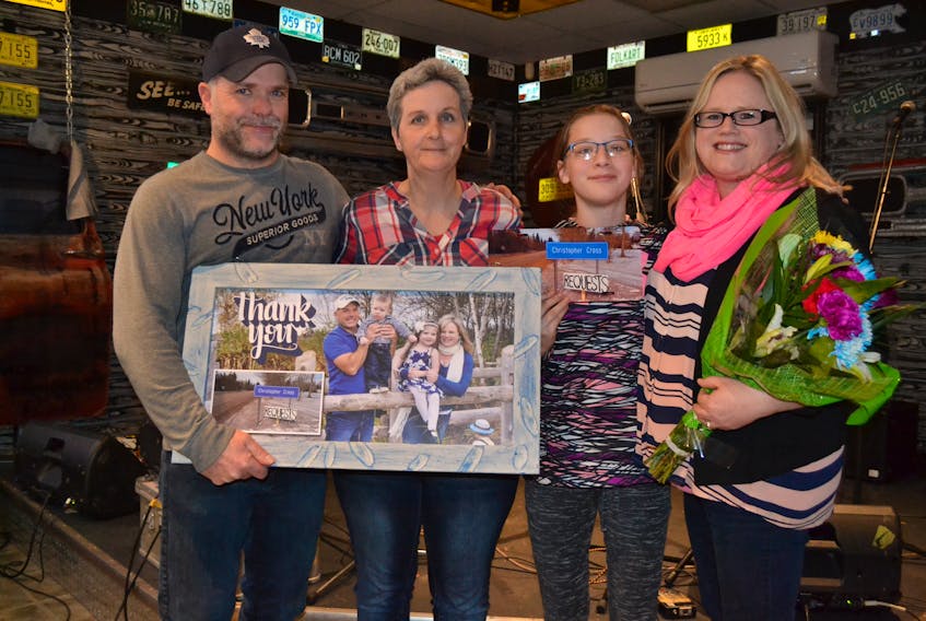 Kim Beaton, second left, and her daughter, Jayden, present Malcolm and Kelly Pitre with “thank you” gifts during an appreciation night recently at Route 145 Bar and Grill in Bloomfield.