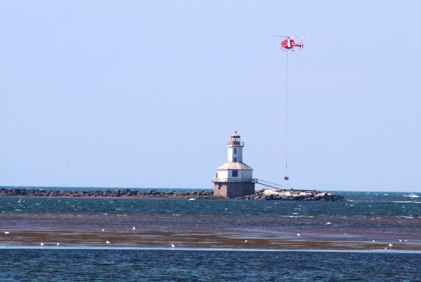 A helicopter is being employed by the Canadian Coast Guard as it works to replace an aged helicopter landing pad at the Indian Head Lighthouse in Summerside Harbour.